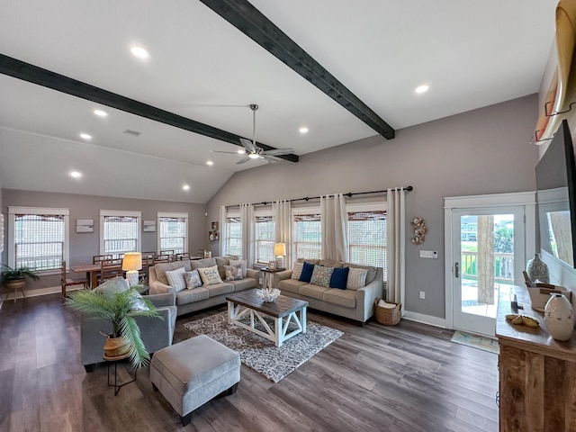 living room featuring a wealth of natural light, wood finished floors, and vaulted ceiling with beams