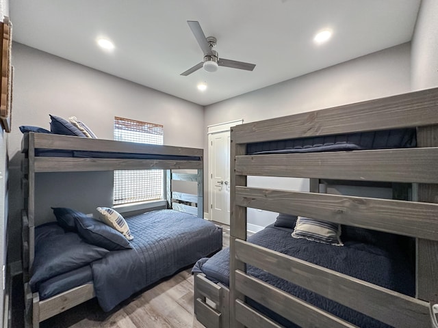 bedroom with ceiling fan, wood finished floors, and recessed lighting