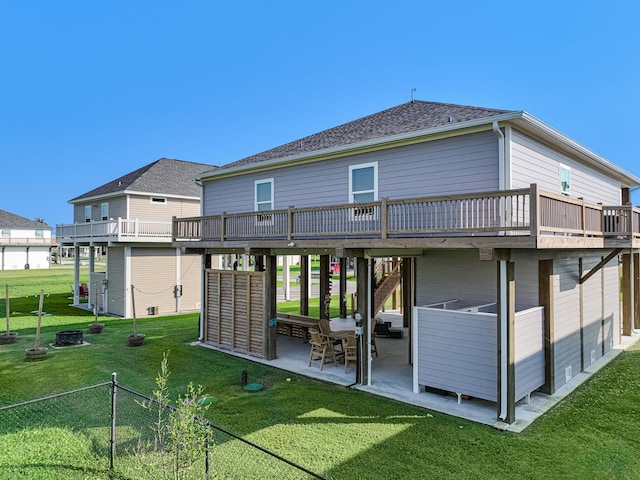 rear view of property with a lawn, a patio, and a wooden deck