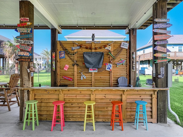 view of patio with fence and outdoor dry bar