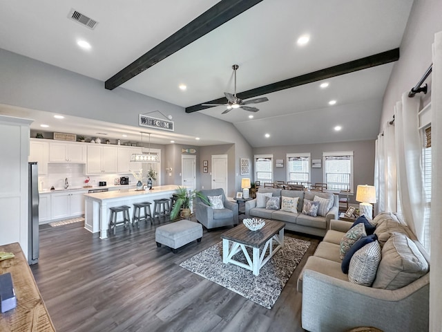 living room with visible vents, a ceiling fan, dark wood finished floors, recessed lighting, and vaulted ceiling with beams