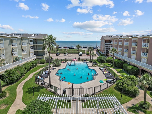 view of pool with a patio and a water view