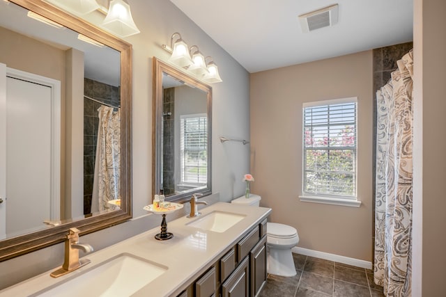 bathroom featuring tile patterned flooring, vanity, and toilet