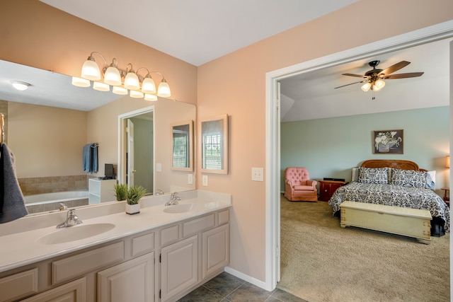 bathroom featuring tile patterned flooring, vanity, a bathtub, and ceiling fan