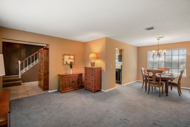 carpeted dining room featuring an inviting chandelier