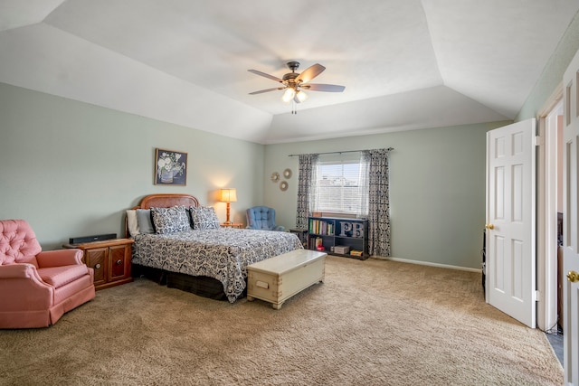 bedroom with a raised ceiling, light colored carpet, vaulted ceiling, and ceiling fan