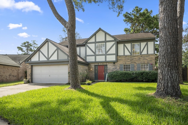 tudor house featuring a front yard and a garage