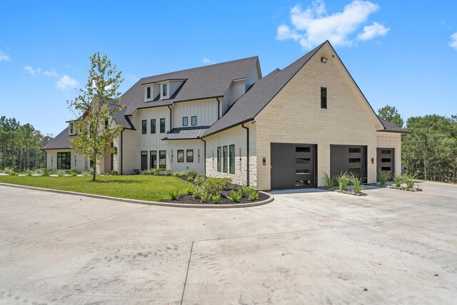 view of front of property with a front yard and a garage