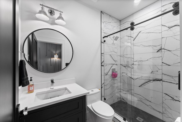 bathroom featuring an enclosed shower, vanity, and toilet