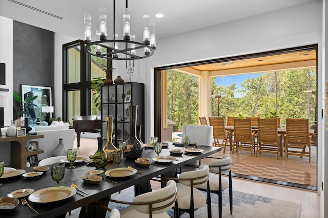 dining area with hardwood / wood-style flooring, a chandelier, and a healthy amount of sunlight