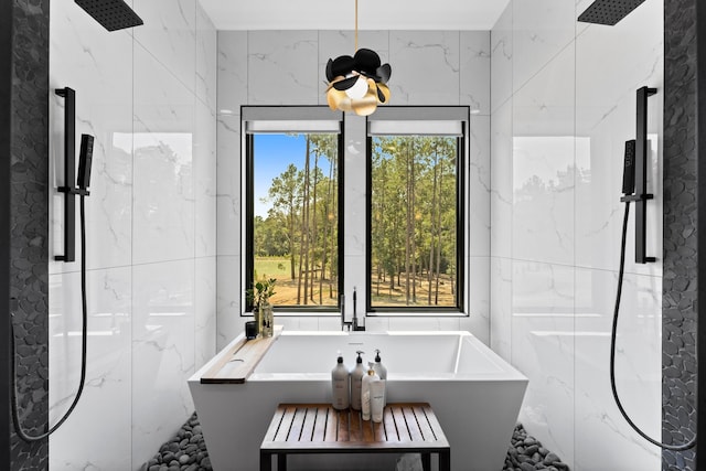 bathroom featuring tile walls and tiled shower