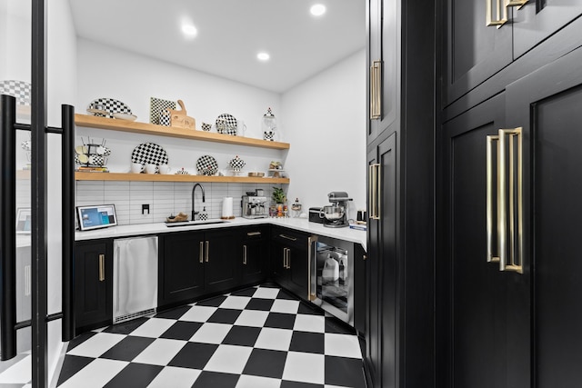 kitchen with light tile patterned floors, decorative backsplash, stainless steel dishwasher, and wine cooler