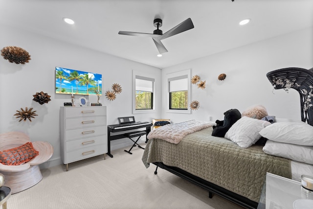 bedroom with ceiling fan and light colored carpet