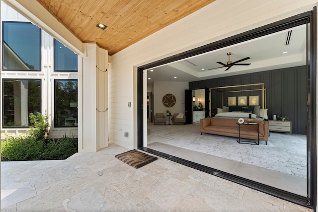 property entrance featuring a patio area and ceiling fan