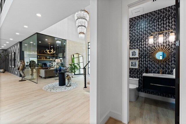 interior space featuring wood-type flooring, sink, and an inviting chandelier