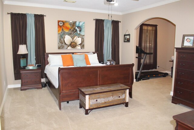 bedroom with crown molding, ceiling fan, and light colored carpet