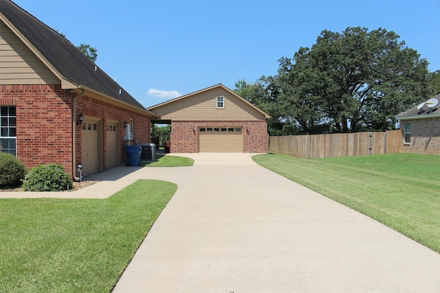 view of front of house featuring an outbuilding, a garage, and a front lawn