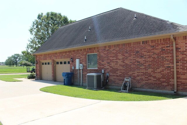 view of home's exterior featuring central AC and a garage