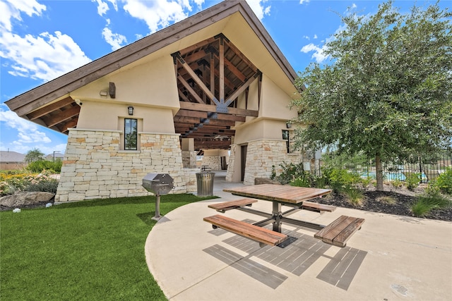 surrounding community featuring a patio area and a lawn