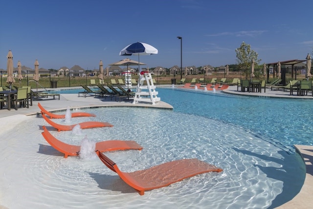 view of swimming pool featuring a water slide and pool water feature