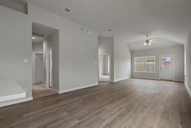 unfurnished room with lofted ceiling, hardwood / wood-style floors, and ceiling fan