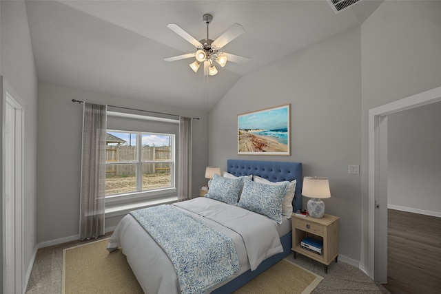 bedroom with ceiling fan, lofted ceiling, and carpet flooring