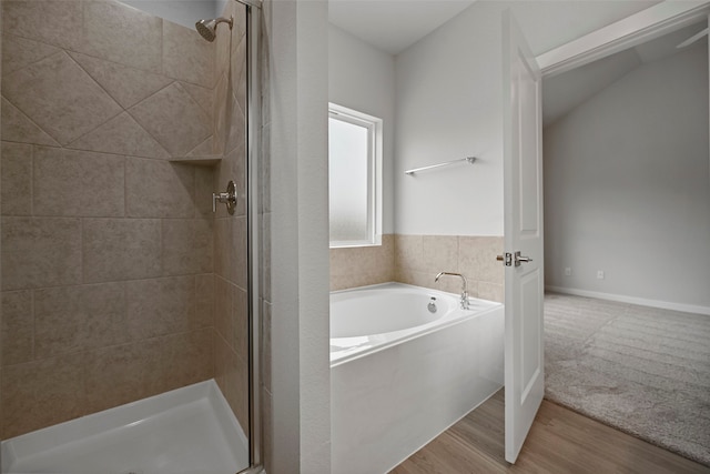 bathroom with hardwood / wood-style floors and separate shower and tub