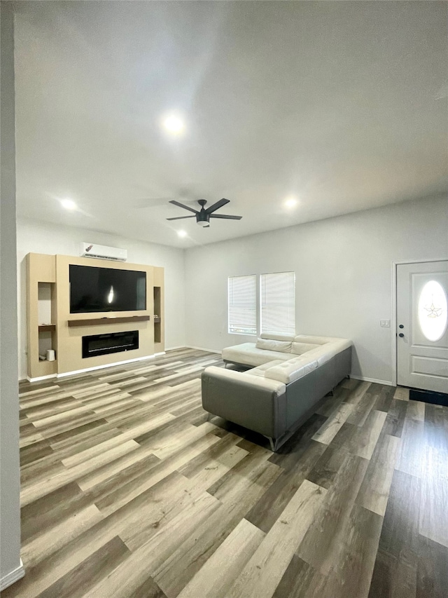 living room with ceiling fan and hardwood / wood-style flooring