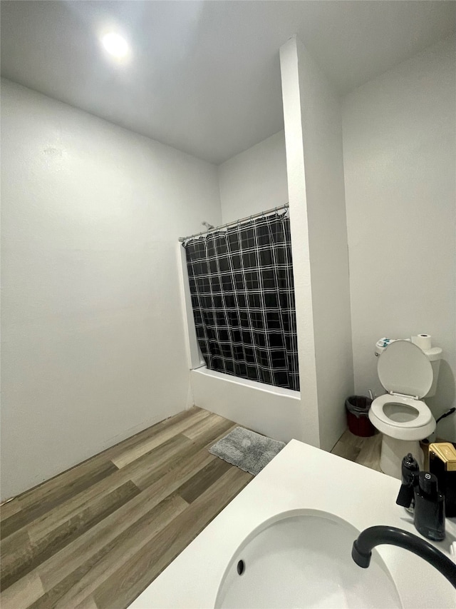 bathroom featuring vanity, walk in shower, toilet, and hardwood / wood-style flooring