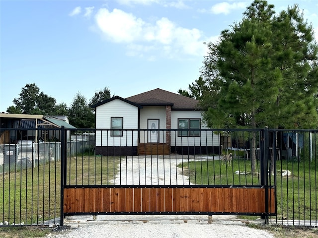 view of gate with a lawn