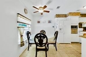 tiled dining area featuring ceiling fan