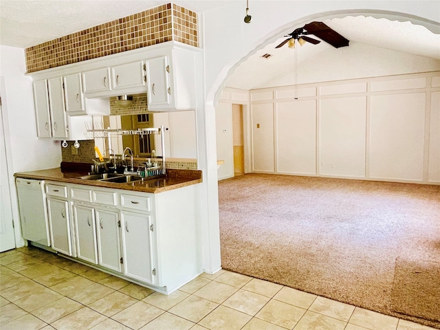 kitchen with dishwasher, white cabinetry, light carpet, and ceiling fan