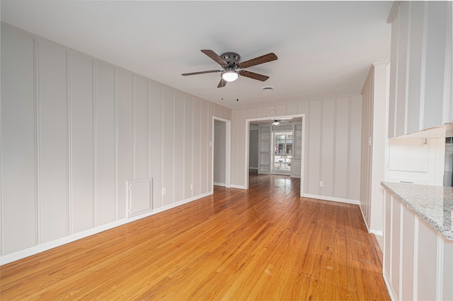 spare room with light hardwood / wood-style flooring and ceiling fan