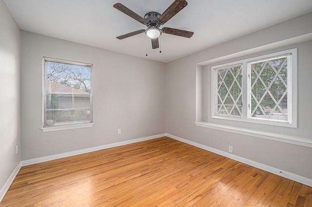 unfurnished room with light wood-type flooring, plenty of natural light, and ceiling fan