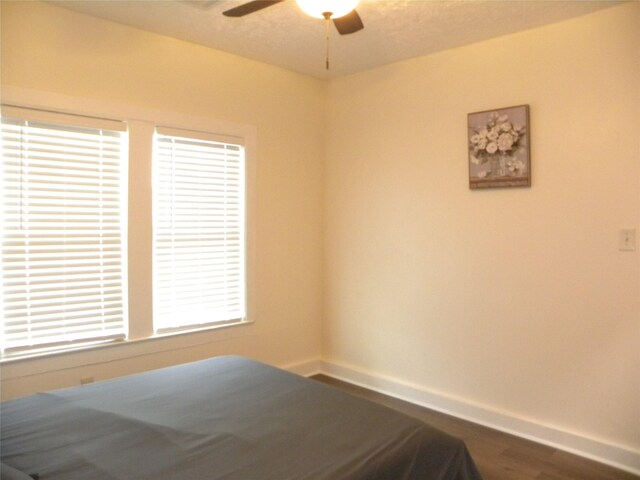 unfurnished bedroom with ceiling fan and hardwood / wood-style floors