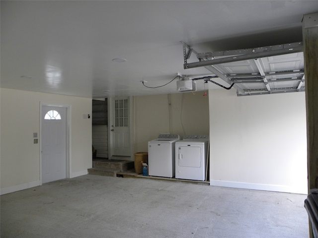 garage featuring washer and dryer and a garage door opener