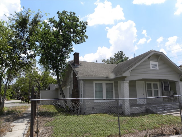 view of side of property with a lawn