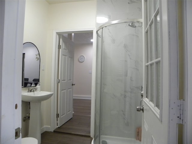 bathroom with walk in shower, hardwood / wood-style flooring, and toilet