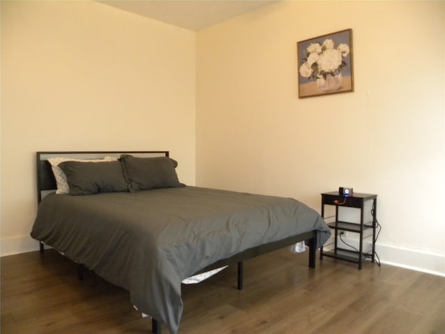 bedroom featuring dark hardwood / wood-style flooring