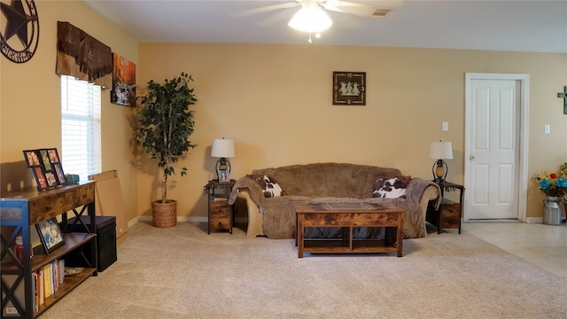 carpeted living room with ceiling fan