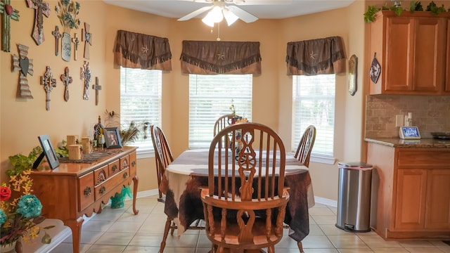 dining space with ceiling fan and light tile patterned floors