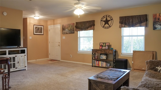 carpeted living room featuring a wealth of natural light and ceiling fan