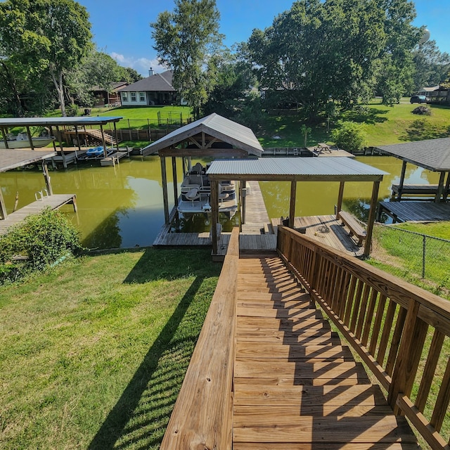 view of dock with a yard and a water view