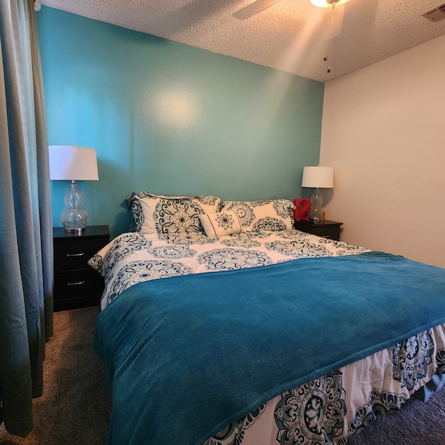 carpeted bedroom featuring a textured ceiling and ceiling fan