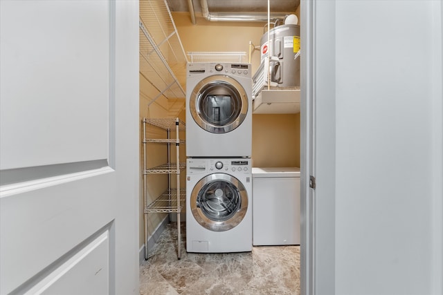 laundry area with light tile patterned flooring and stacked washer and clothes dryer