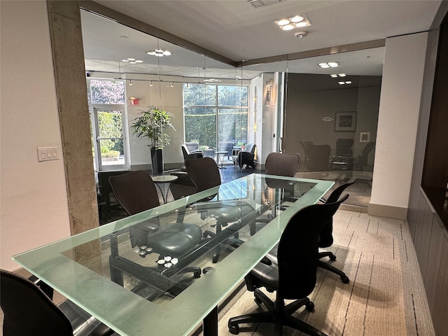 dining area featuring plenty of natural light and expansive windows