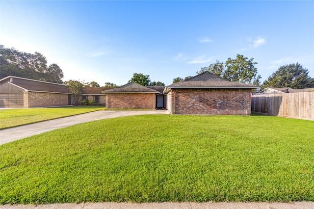 ranch-style home with a front yard and a garage