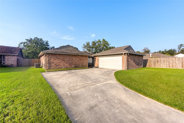 ranch-style house featuring central AC unit, a garage, and a front lawn