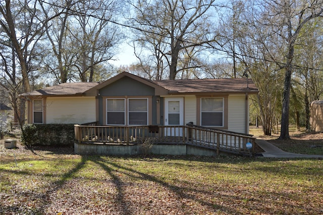 view of front of house with a front yard and a deck