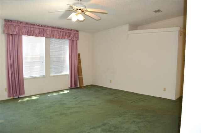 unfurnished room with ceiling fan, ornamental molding, a textured ceiling, and dark colored carpet